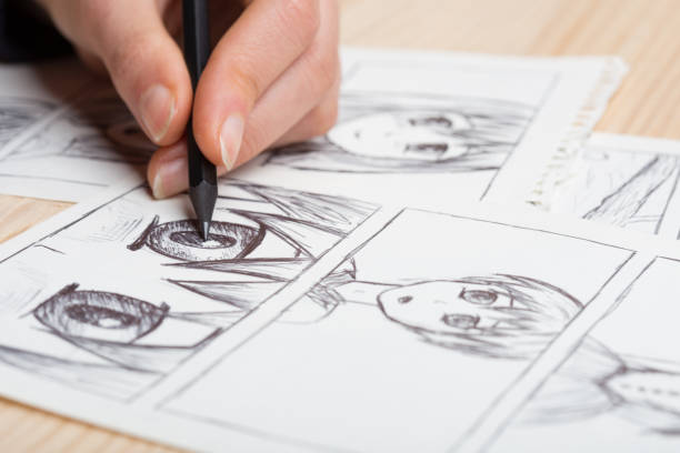 Artist drawing an anime comic book in a studio. Artist drawing an anime comic book in a studio. manga style stock pictures, royalty-free photos & images