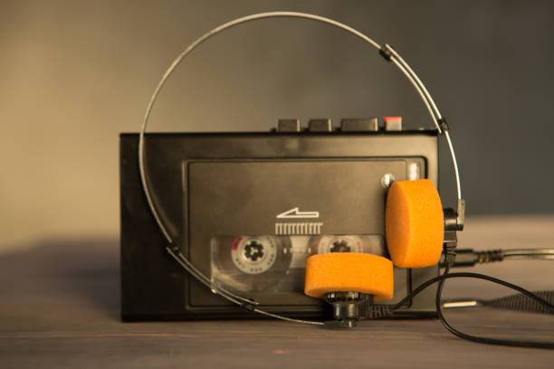 istock Old portable cassette player and headphones on a abstract background. Vintage advertisement style 1241572549