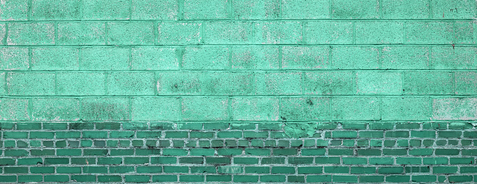 Aqua menthe colored brick wall, green painted brick panoramic background, horizontal aspect