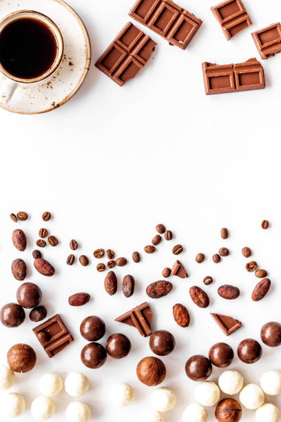 istock Candy background with chocolate and coffee on white desk top view frame pattern. Cafe concept. Copy space 1241578990