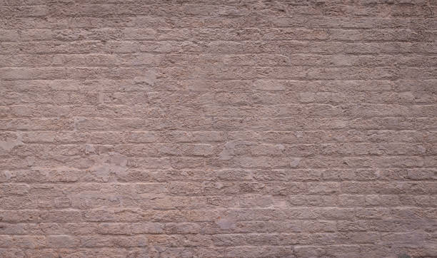 istock Large panoramic backdrop of painted brick and plaster in subtle warm shades 1241578994