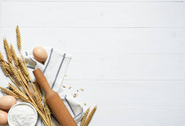 istock Baking background with flour, wheat ears and rolling pinon concrete background. Top view with copy space. 1241579008