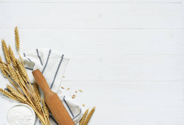 istock Baking background with flour, wheat ears and rolling pinon concrete background. Top view with copy space. 1241579235