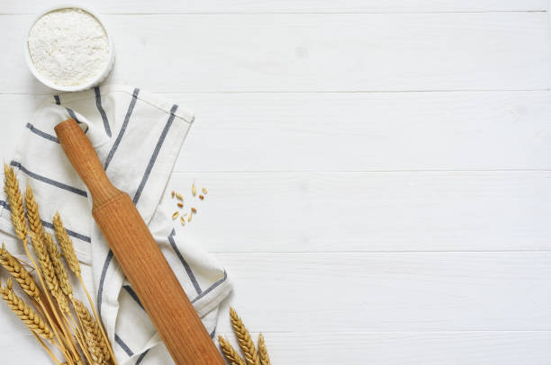 istock Baking background with flour, wheat ears and rolling pinon concrete background. Top view with copy space. 1241579393