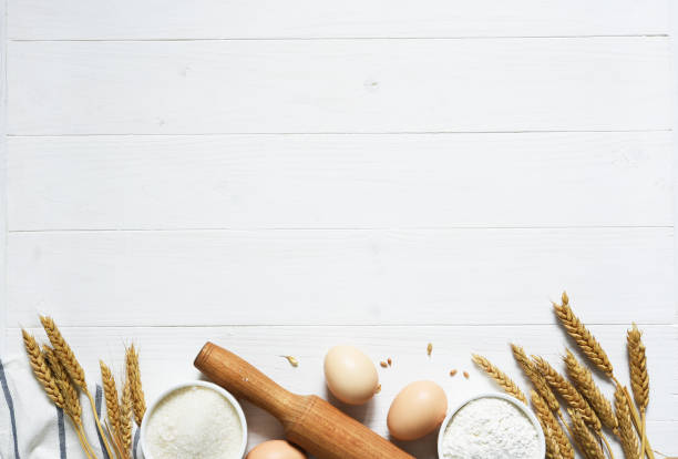 istock Baking background with flour, wheat ears and rolling pinon concrete background. Top view with copy space. 1241579526