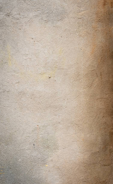istock Concrete wall texture with subtle coloration variations in tan, gray, and brown shades 1241580059