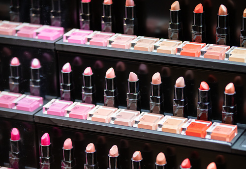 Set of lipsticks on shelves in cosmetics beauty store