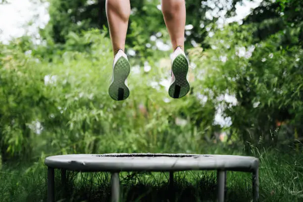 a sport woman jumping on a trampoline