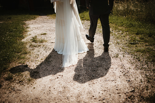 a wedded couple walking in a park