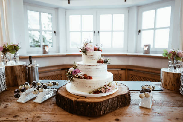 photo of wedding cake with flowers on a table wedding cake with flowers on a table wedding cake stock pictures, royalty-free photos & images