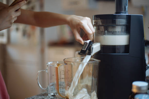 istock Woman making home made almond milk 1241614612