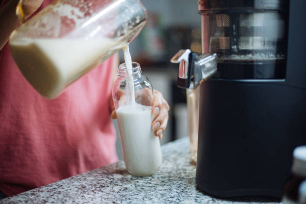 istock Woman making home made almond milk 1241616331