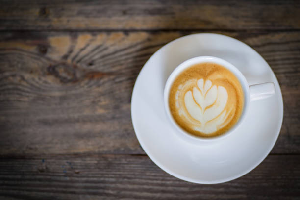 istock latte art coffee or cappuccino on wooden table background 1241617528