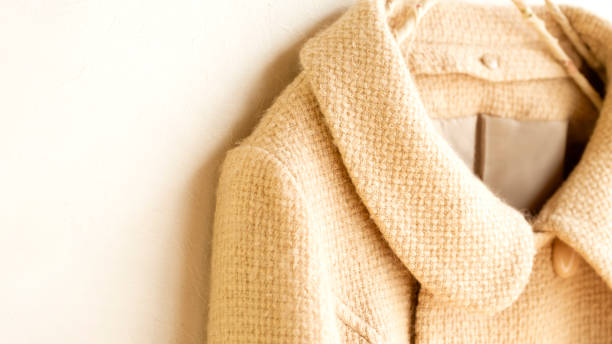 istock white wool short coat hanging on clothes hanger on white background 1241624460