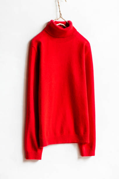 istock red wool sweater hanging on clothes hanger on white background.close up. 1241625802