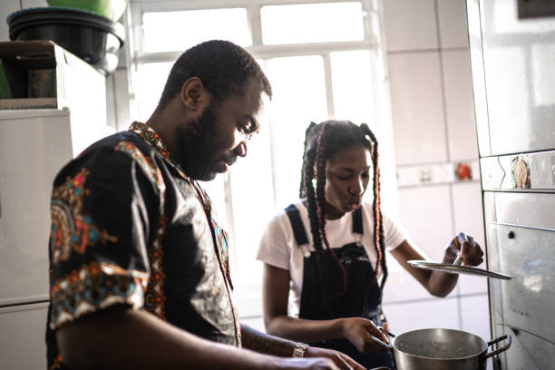 istock Dad and daughter cooking at home 1241626173