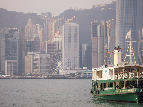 Hong Kong Star Ferry in the Victoria Bay, cloudy sky
