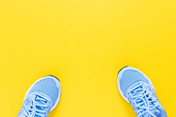 istock Blue sneakers isolated on a yellow background 1241639660