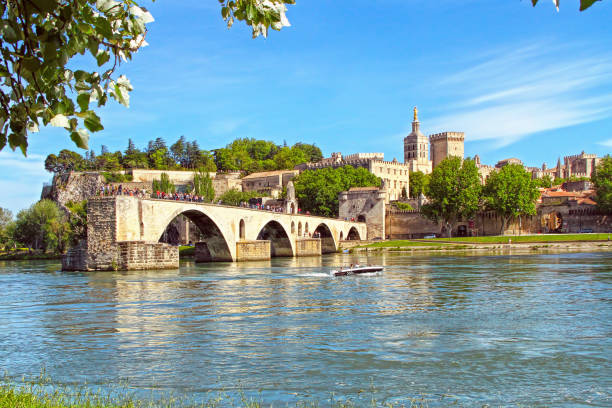 Avignon, France - May 08, 2014: tourists in the boat in front of the Avignon's bridge and The Popes Palace in Avignon ( city of Popes), France