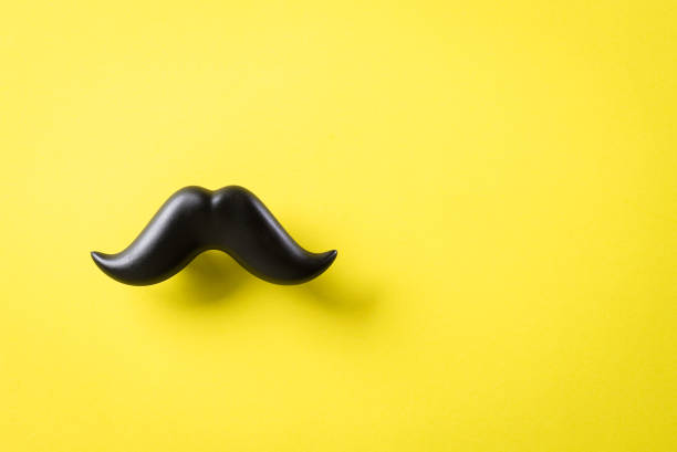 istock Father's day concept. Black moustache on yellow paper background. 1241648541
