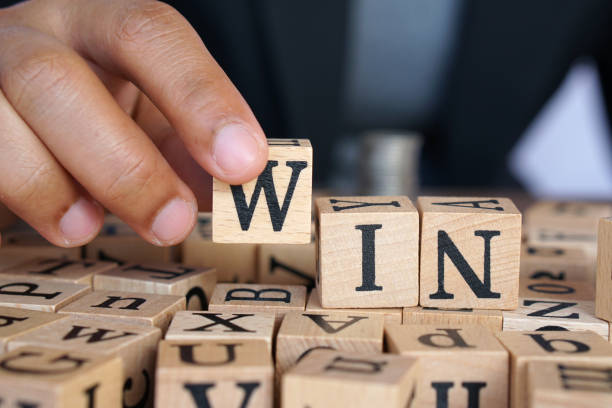 istock Human hands against the word win 1241660691