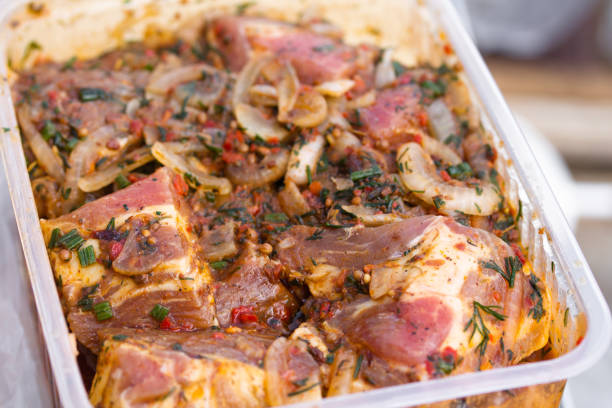 istock Raw marinaded juicy pork meat in plastic container 1241661268