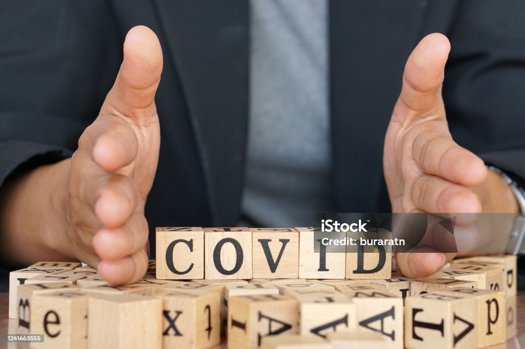 covid-19 writing in pieces of wood letters similar to in a scrabble game Coronavirus Stock Photo