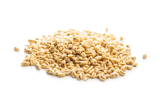 Puffed wheat covered with honey isolated on white background.