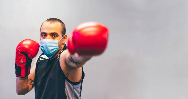 istock Latin boxer with mask and red gloves 1241671117