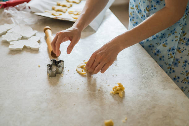 istock Mother and daughter making gingerbread man on the kitchen 1241674385