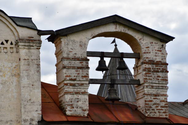 istock Three bells in a whitewashed brick and cement arch waiting to be rung 1241680544
