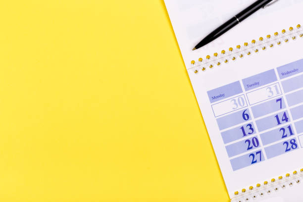 istock White clean calendar 2020  on solid yellow background with copy space, business meeting schedule, travel planning or project milestone and reminder concept. 1241688989