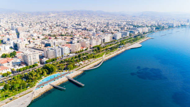 Aerial view of Molos, Limassol, Cyprus Aerial view of Molos Promenade park on the coast of Limassol city centre in Cyprus. Bird's eye view of the jetties, beachfront walk path, palm trees, Mediterranean sea, piers, rocks, urban skyline and port from above. limassol marina stock pictures, royalty-free photos & images