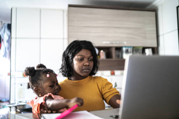 istock Mother doing homeoffice while holding her baby girl 1241709646