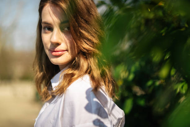 istock Young brunette student girl looking at camera and smiling. 1241712503