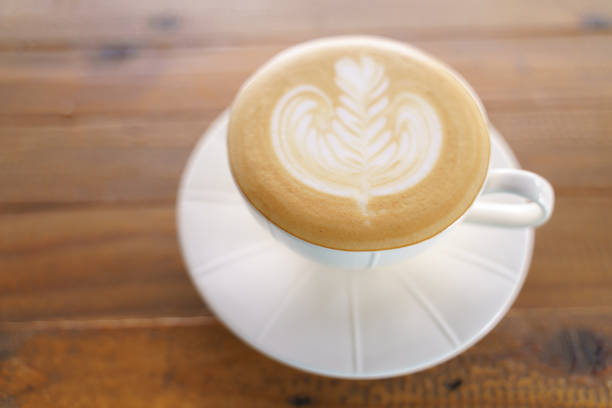 Cup of coffee with latte art pattern milk foam