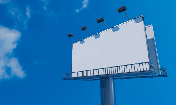 istock Large advertising pole blank advertising billboard signpost with the blue clear sky during the daytime. 3D Rendering 1241738983