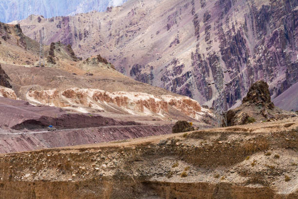 High voltage lines in Lamayuru moonland, picturesque lifeless mountain landscape on a section of the Leh-Kargil route in the Himalayas in the vicinity of the Buddhist monastery Lamayuru (Ladakh, India) High voltage lines in Lamayuru moonland, picturesque lifeless mountain landscape on a section of the Leh-Kargil route in the Himalayas in the vicinity of the Buddhist monastery Lamayuru (Ladakh, India) in a sunny summer day. Steep slopes, erosion of impassable rocks, narrow gorge moonland stock pictures, royalty-free photos & images