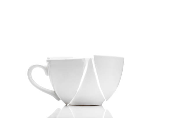 istock white ceramic cup broken into fragments as a result of the fall, a concept of a kitchen object on the theme of crisis on a white background with copy space. 1241745708