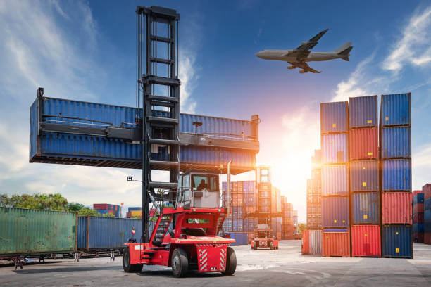 istock Container Cargo Port Ship Yard Storage of Logistic Transportation Industry. Forklift is Stacking Containers of Freight Import/Export Shipment. Business Shipping Logistics Service Transport Industrial 1241747907