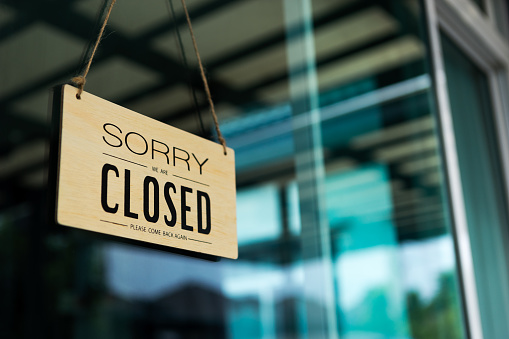 Etiqueta 'Sorry we are closed please come back again' aviso de cartel de madera tablón de madera colgando en la puerta de la cafetería. photo