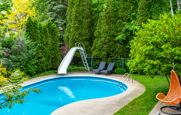 Backyard Swimming Pool Backyard Swimming Pool With a Water Slide back yard stock pictures, royalty-free photos & images