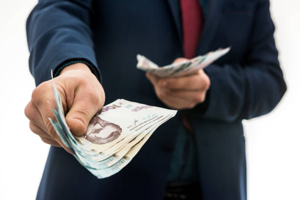 businessman gives bribe or pay, in isolation. UAH. 1000 new banknote Ukrainian money businessman gives a bribe or pay, in isolation. UAH. 1000 new banknote Ukrainian money ukrainian currency stock pictures, royalty-free photos & images