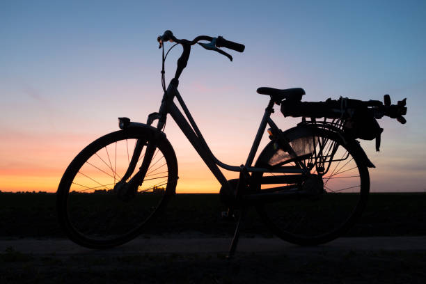 istock Silhouette of a bicycle against colorful sky 1241772837
