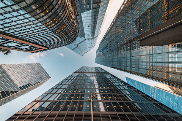 Looking directly up at the skyline of the financial and business brand new district in central City of London on a bright sunny afternoon - creative stock image stock photo