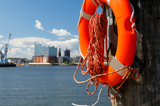 Rescue ring in front of the Elbphilharmonie and the Tower of St. Michaelis Church