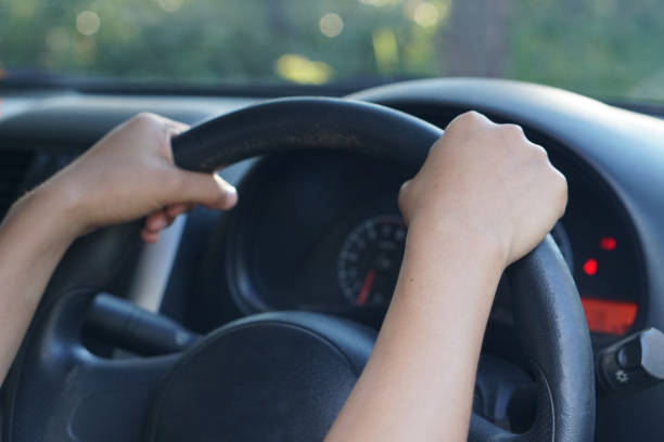 istock human hand holding a steering wheel to drive a car 1241787410