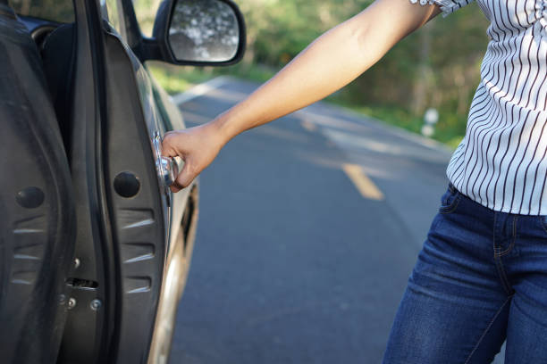 istock woman's hand opens the car's door. 1241790212