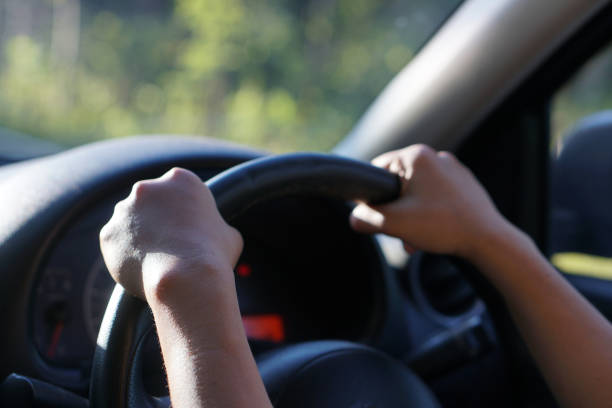 istock human hand holding a steering wheel to drive a car 1241796857
