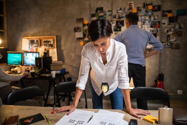 istock Police woman working late at night at office 1241799559